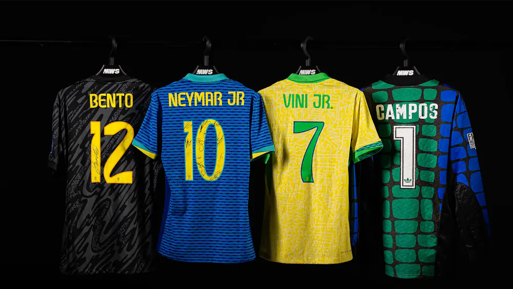 Four soccer jerseys hang in a row, featuring names Bento, Neymar Jr, Vini Jr, and Campos, in different colors and designs.