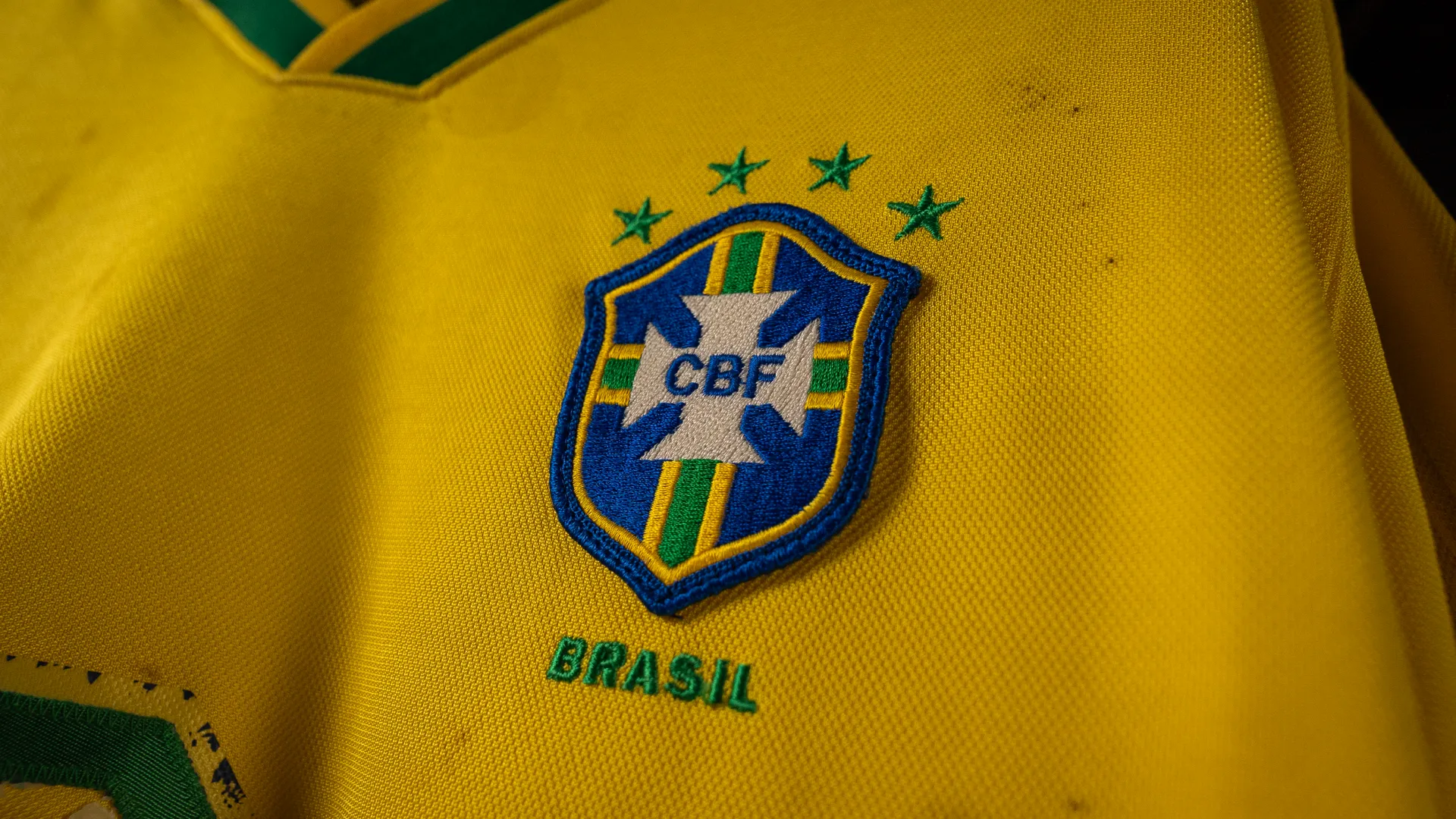 Close-up of Dunga's Brazilian national soccer team yellow jersey featuring the CBF logo with green stars and "Brasil" embroidered below.