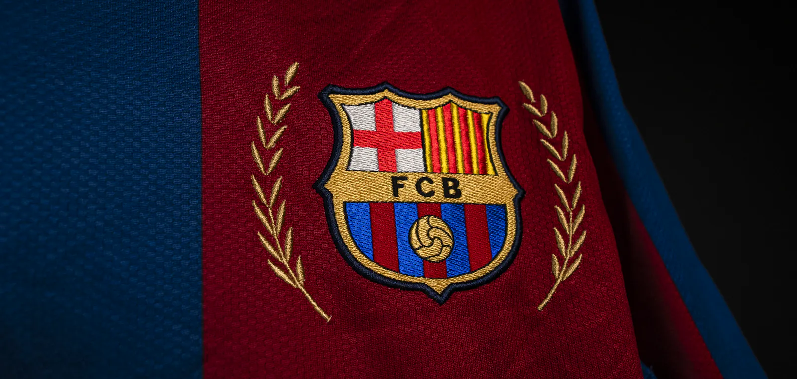 A close up of a Barcelona crest on a shirt