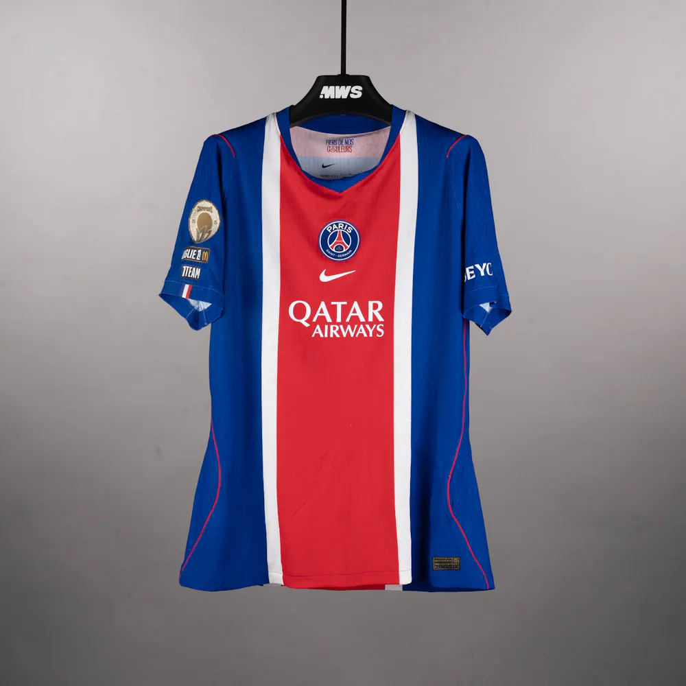 A blue and red Paris Saint-Germain FC soccer jersey featuring Qatar Airways logo, displayed on a black hanger.
